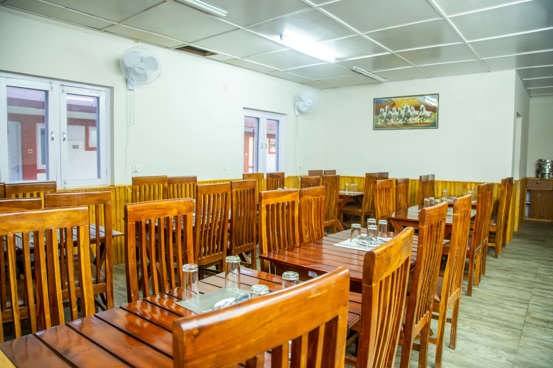 Indoor dining hall with rows of wooden tables